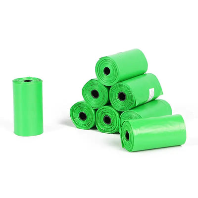 Green plastic bags stacked on a white background
