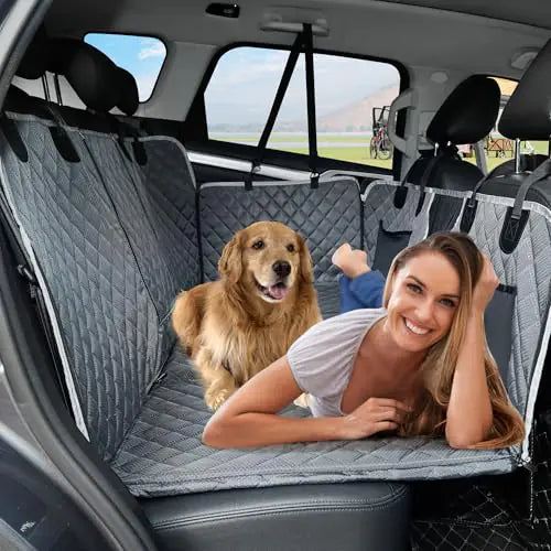 Woman securing her dog in premium waterproof pet car seat with safety harness for safe travel
